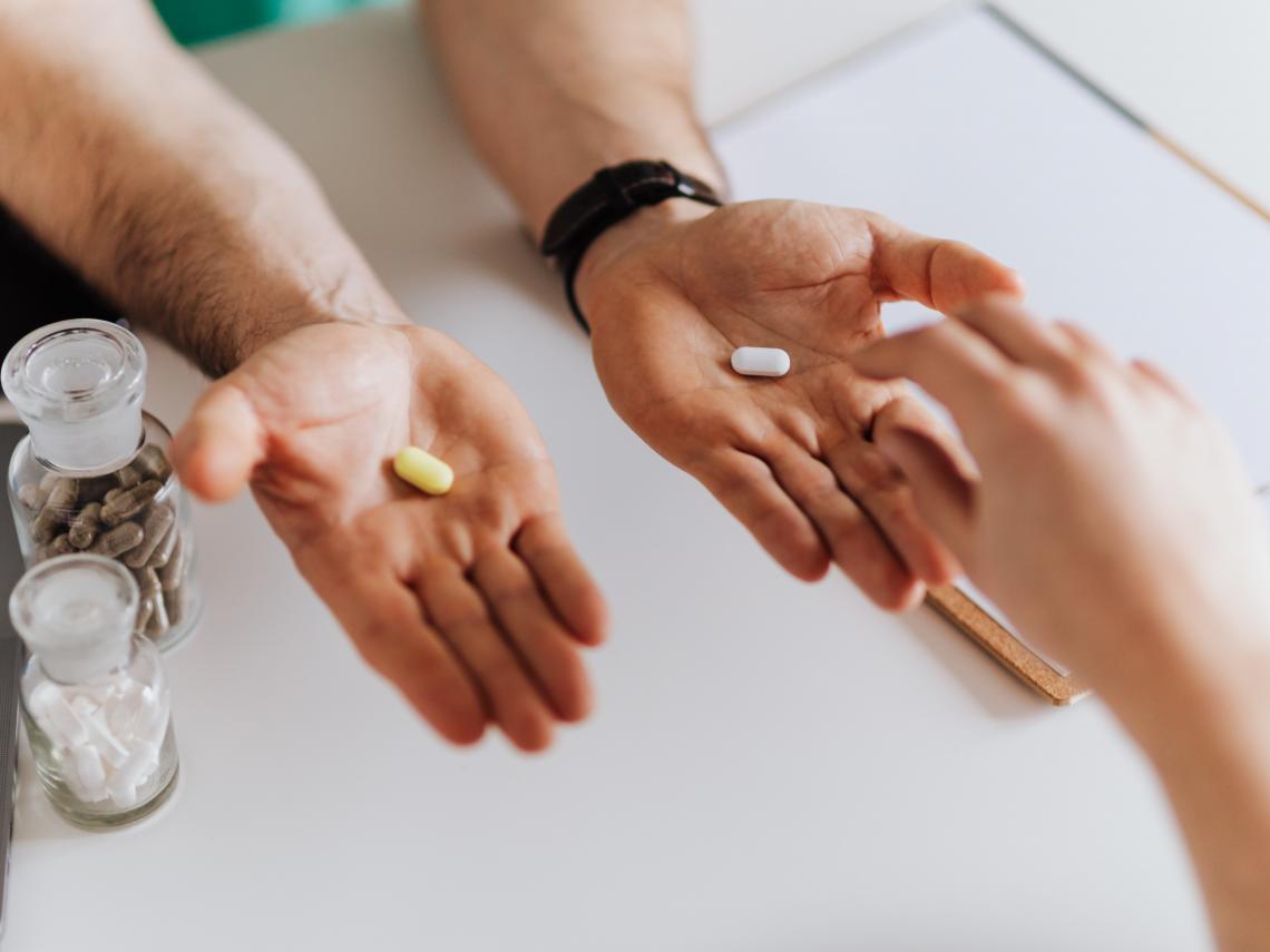 hands holding pills